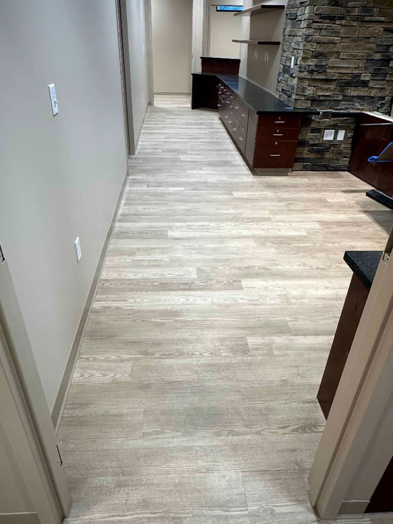 Commercial hallway with newly installed hardwood-style flooring