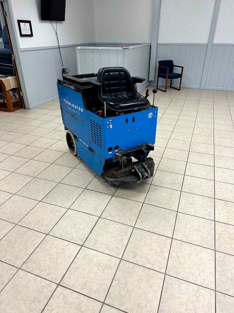 Floor demolition equipment on a tile floor before removal